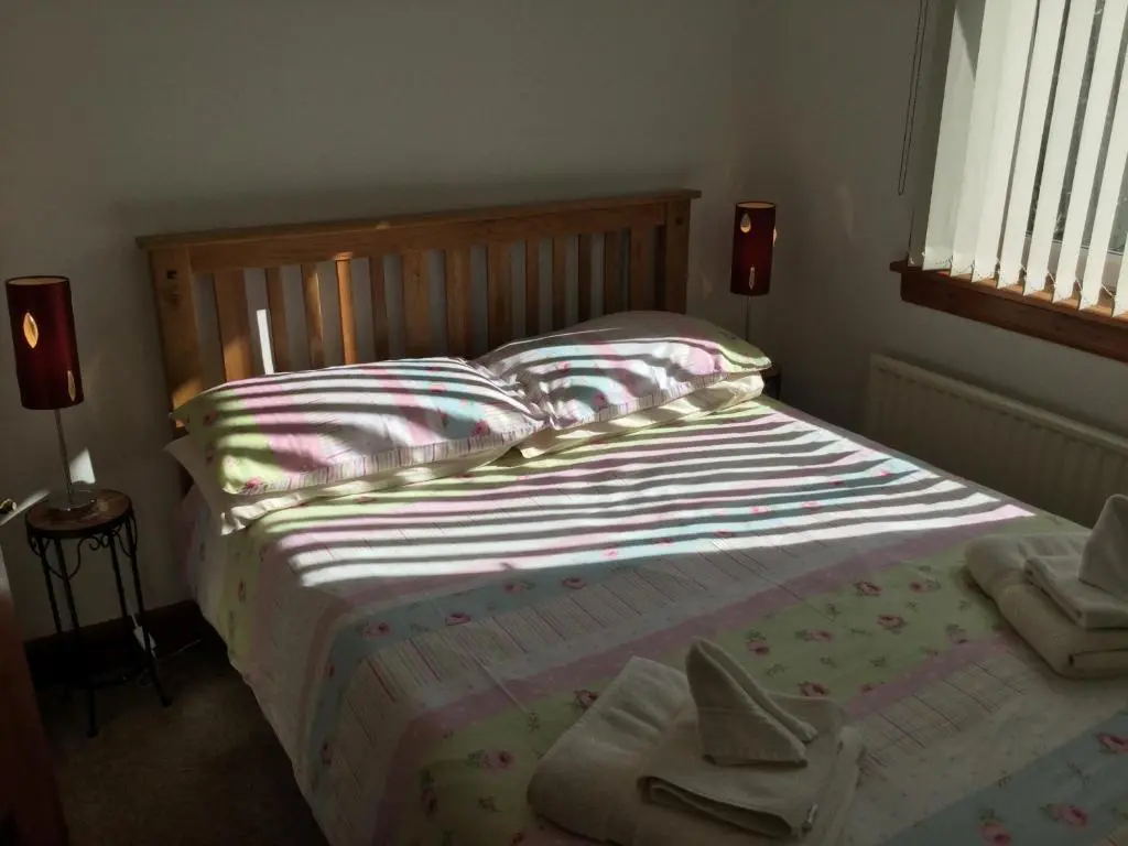 a bedroom with a bed with towels on it at 3 Bedroom Culduthel House Free Parking in Inverness