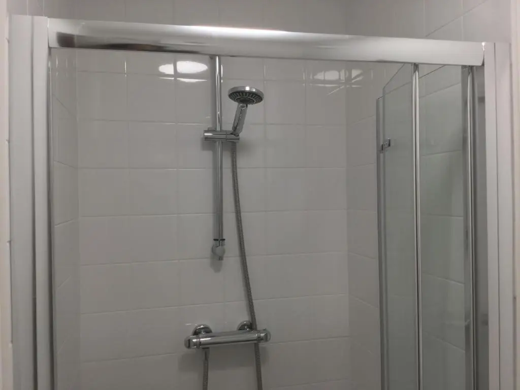a shower with a glass door in a bathroom at 3 Bedroom Culduthel House Free Parking in Inverness