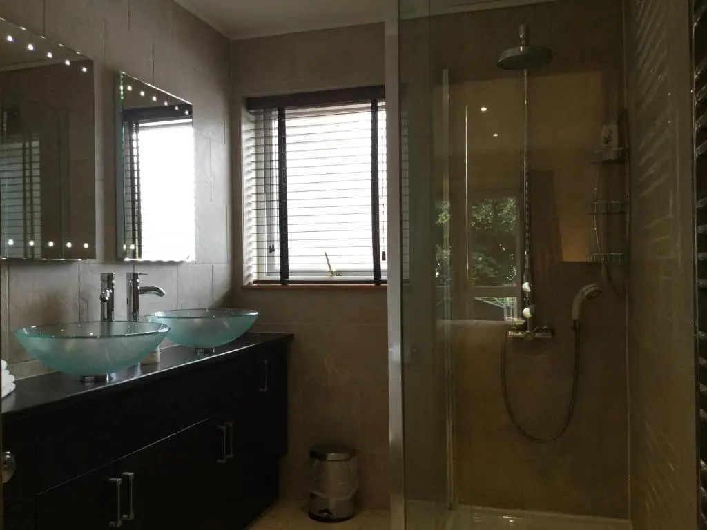 a bathroom with two sinks and a shower at Four-Bedroom House - Stratherrick Free Parking in Inverness