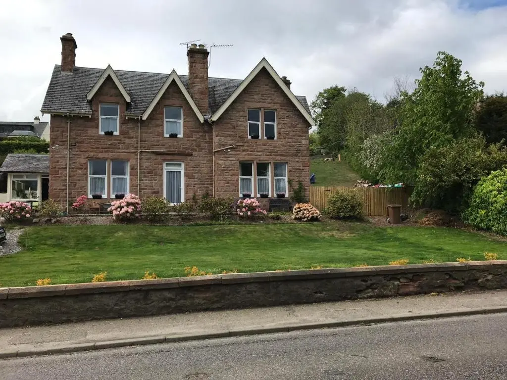 a house on the side of a road at Cromarty View Guest House Accommodations & B&B in Dingwall