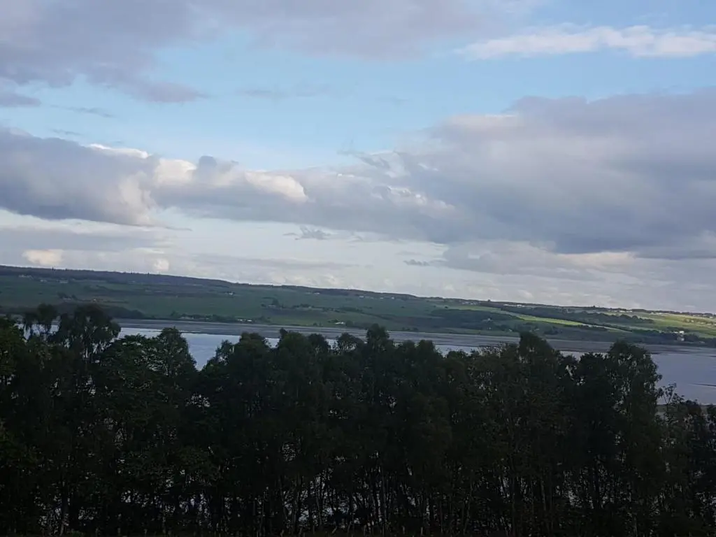 a view of a river with trees in the foreground at Cromarty View Guest House Accommodations & B&B in Dingwall