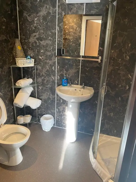 a bathroom with a sink and a toilet and a shower at Cromarty View Guest House Accommodations & B&B in Dingwall