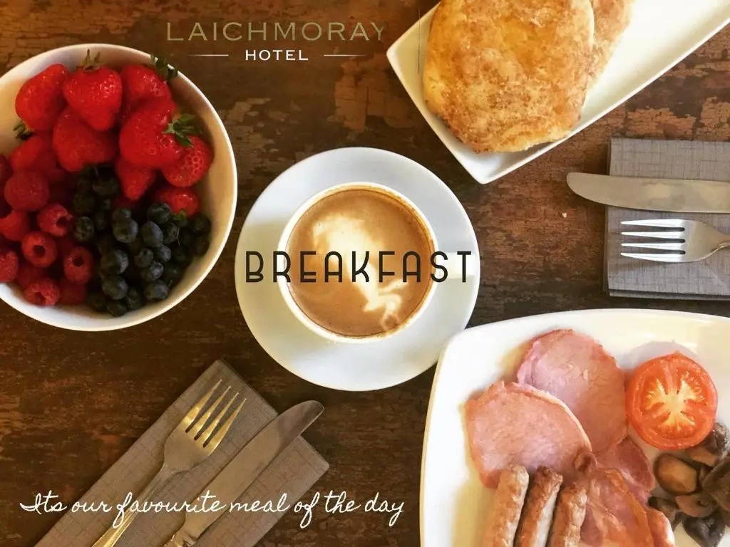 a table with plates of food and a cup of coffee at Laichmoray Hotel in Elgin