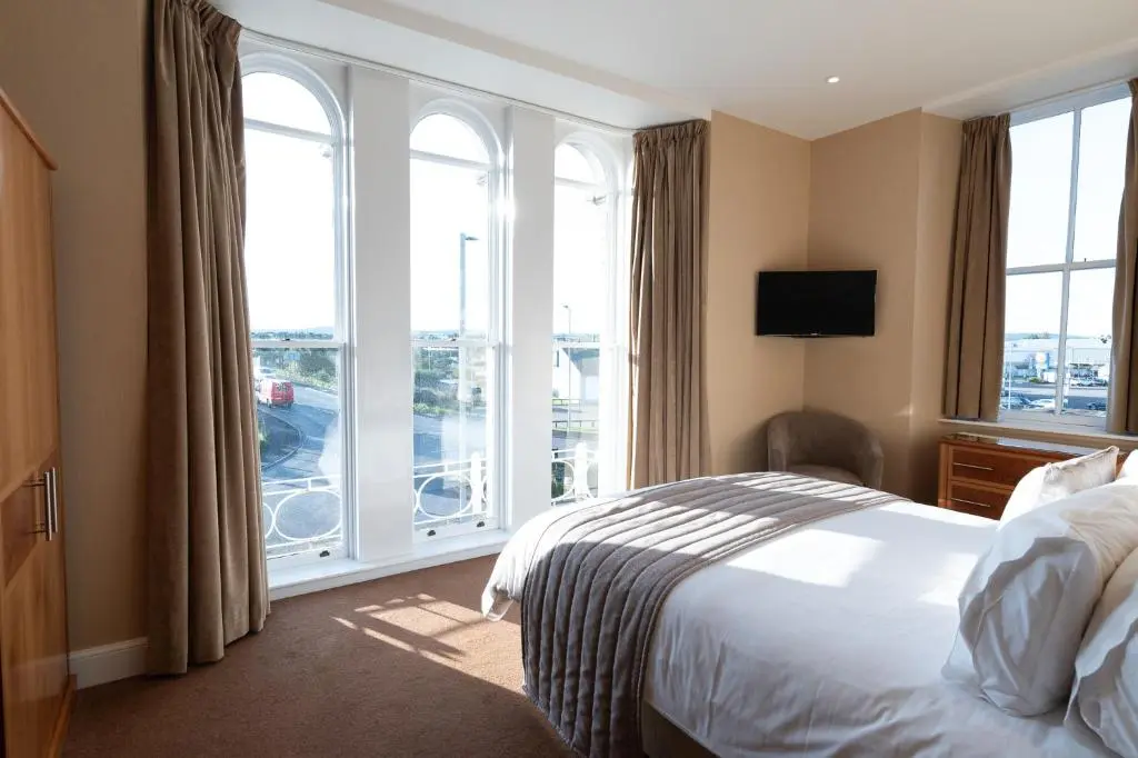 a hotel room with a bed and a large window at Laichmoray Hotel in Elgin