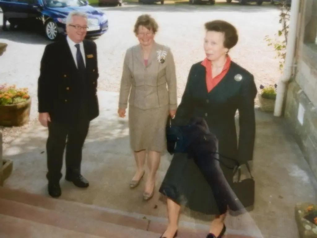 two women and a man standing next to a woman at Mansfield Castle Hotel in Tain