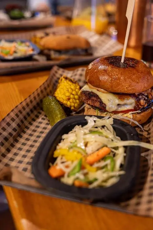 a plate of food with a hamburger and a salad at Coylumbridge Resort Hotel in Aviemore