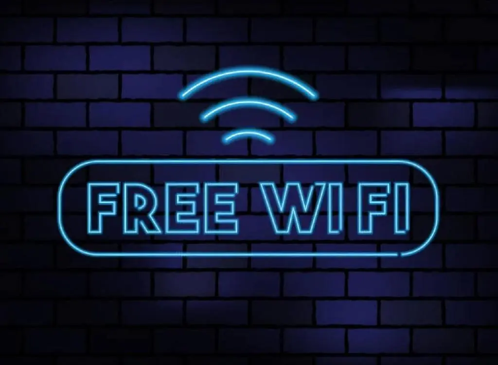 a neon sign with a free wifi sign on a brick wall at Coylumbridge Resort Hotel in Aviemore