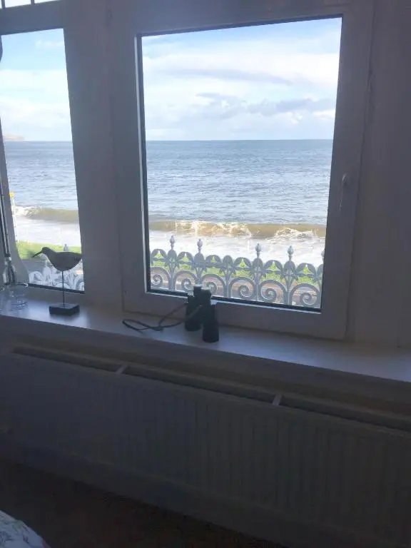 a window with a view of the ocean at Tigh Na Mara Guest House Rosemarkie- breakfast optional in Rosemarkie