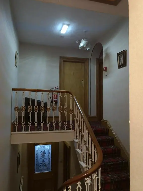 a spiral staircase in a house with a stair case at Granville Guest House in Dyce