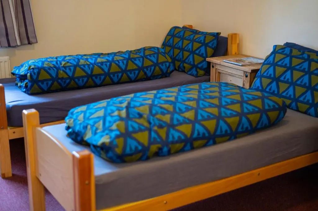 a room with a bed and a couch and a table at Aviemore Youth Hostel in Aviemore
