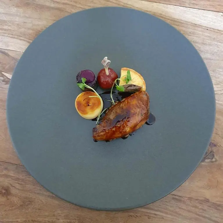 a plate of food with vegetables on a table at The Lovat, Loch Ness in Fort Augustus