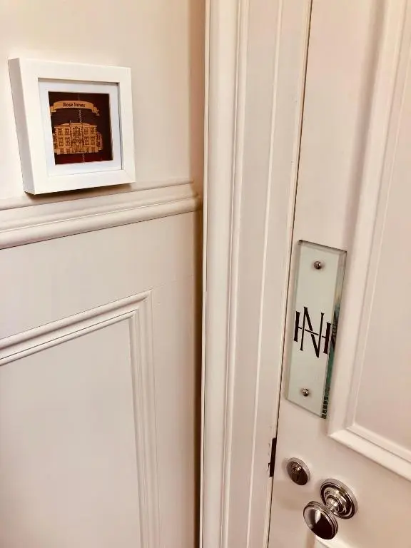 a door with a picture of a building on it at Netherdale House & The Coach House in Turriff