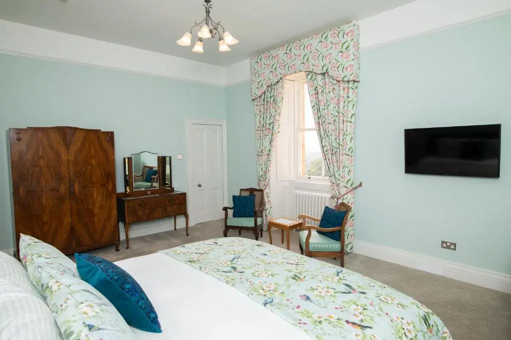 a bedroom with a bed and a window at Netherdale House & The Coach House in Turriff