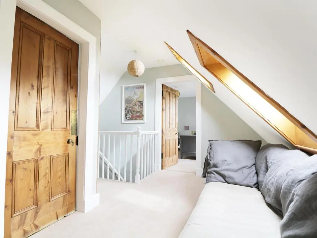 a bedroom with a staircase and a couch in a house at Annfield in Aberlour
