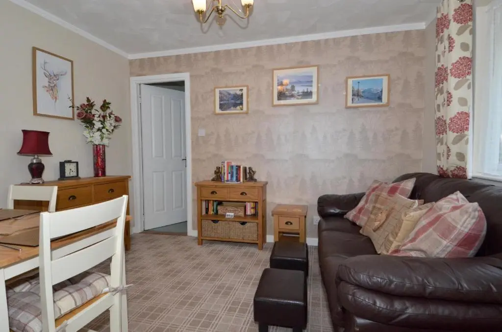 a living room with a couch and a table at The Bridge Suite in Invermoriston