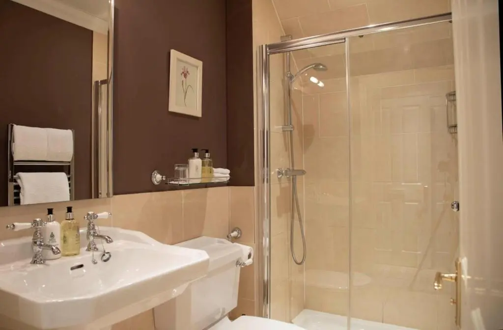 a bathroom with a shower and a sink at Loch Ness Lodge in Drumnadrochit