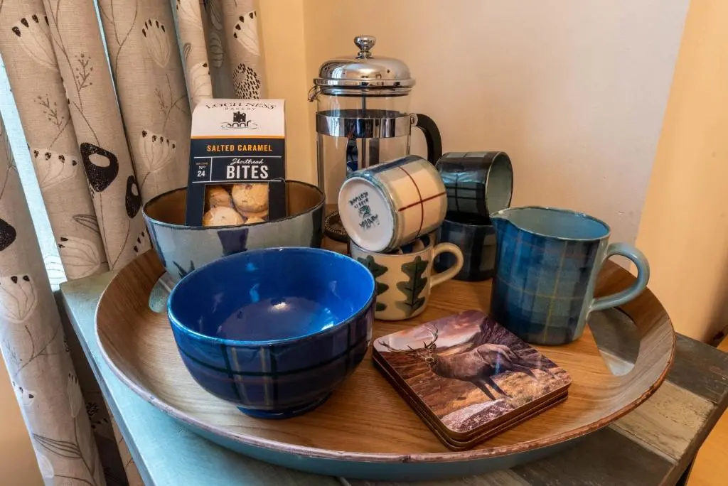 a tray with bowls and cups on a table at No.3 On The Square in Beauly