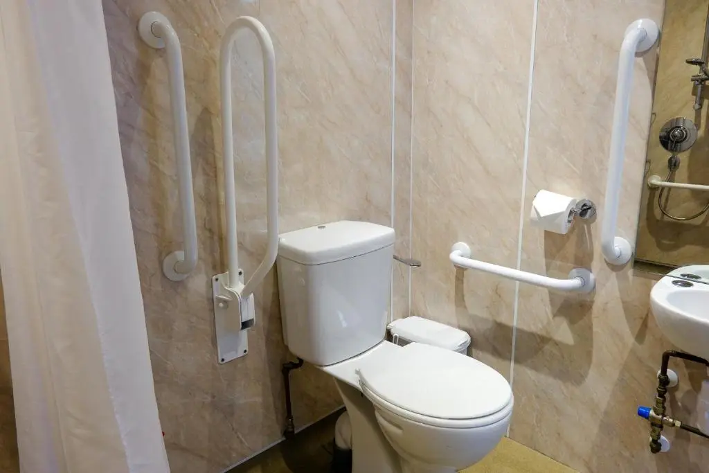 a bathroom with a toilet and a sink at Glen Mhor Hotel at Uile-bheist 'Brewstillery' in Inverness
