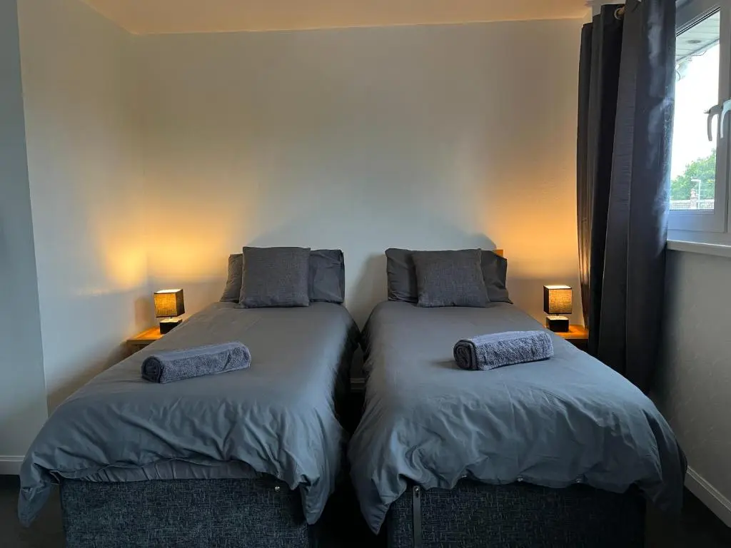 two beds sitting next to each other in a room at Inverness House in Inverness