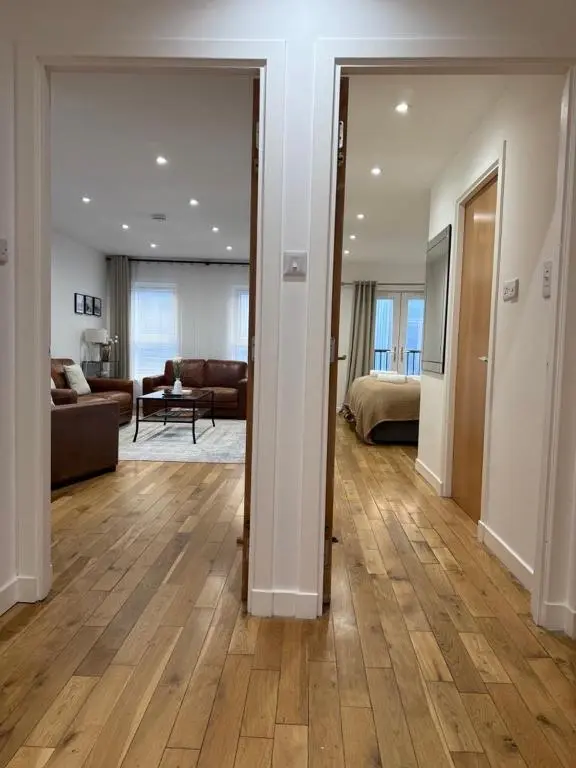 a large living room with a couch and a living room at Gateway Apartment in Inverness
