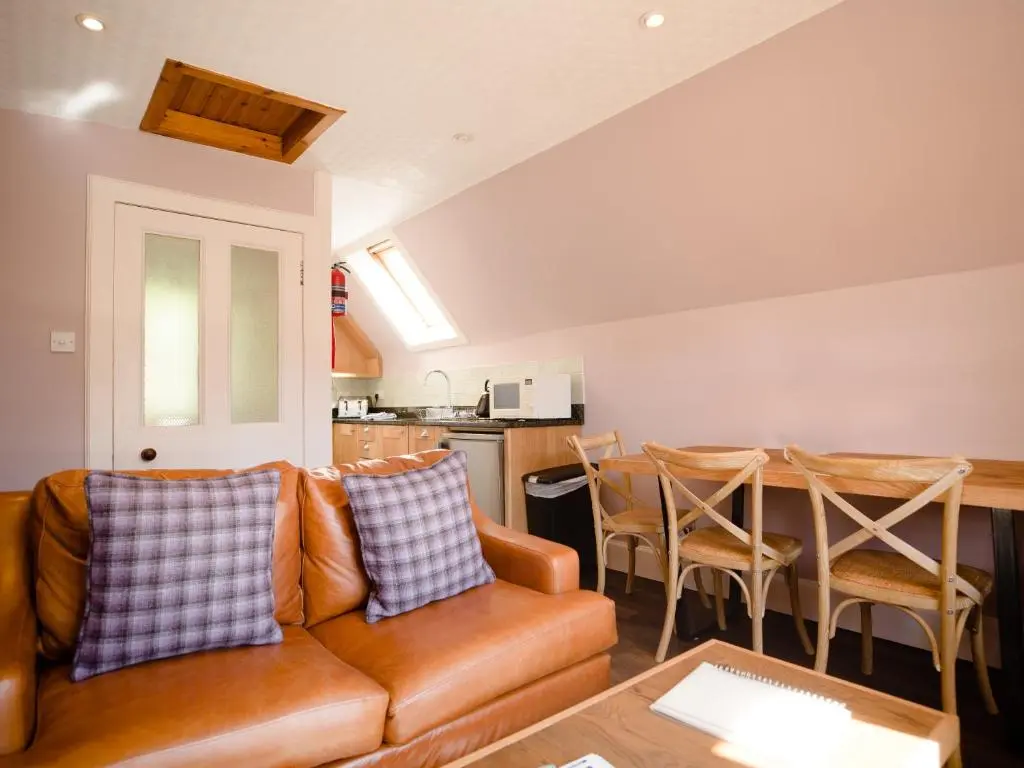 a living room with a couch and a table at Ptarmigan in Aviemore