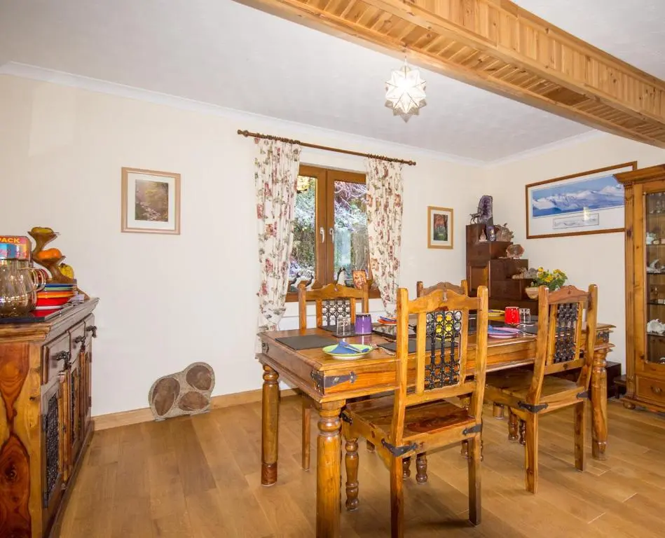 a dining room with a wooden table and chairs at Craik Na Dav B&B in Invermoriston