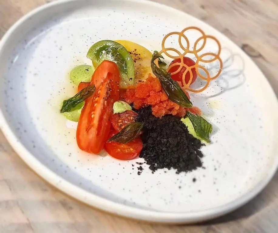 a plate of food with vegetables on a table at Newmachar Hotel in Newmachar