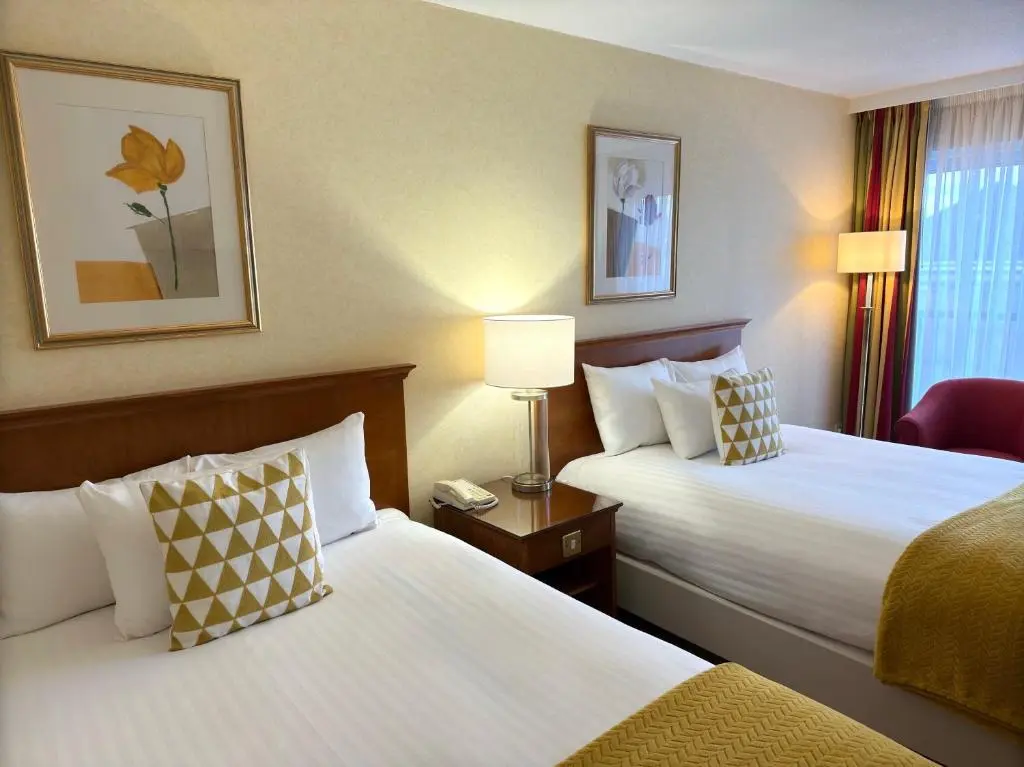 a hotel room with two beds and a window at The Aberdeen Dyce Hotel in Dyce