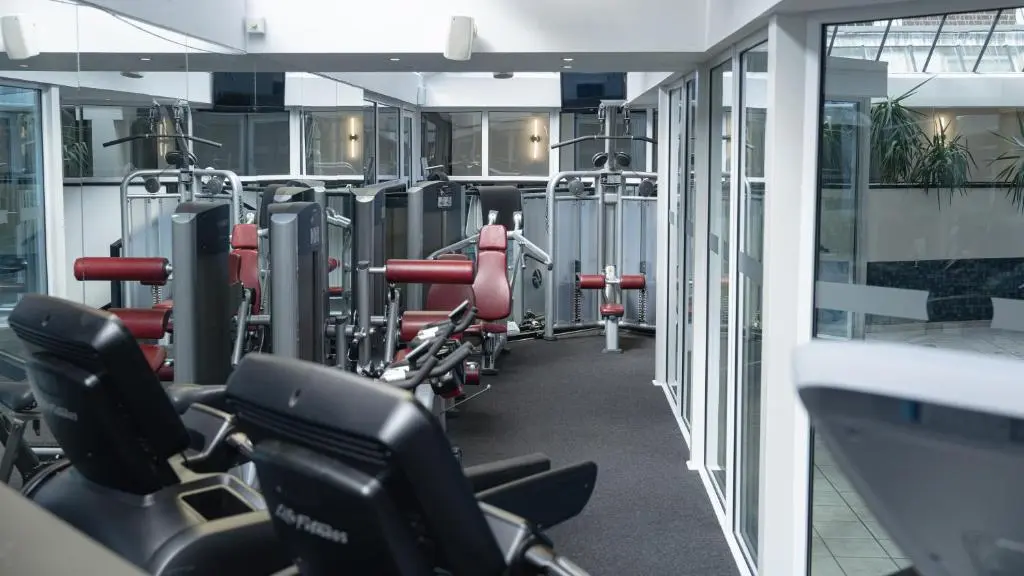 a gym with a row of cardio machines at The Aberdeen Dyce Hotel in Dyce
