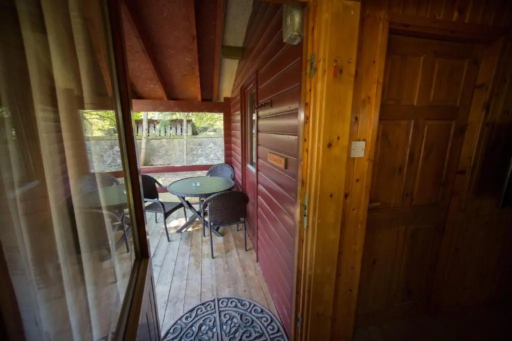 an inside view of a cabin with a table and chairs at Invercauld Lodges in Ballater