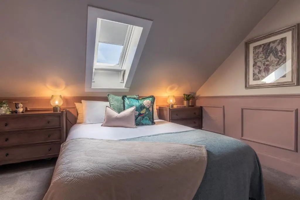 a bedroom with a bed with pillows and a window at The Nessting Place in Inverness