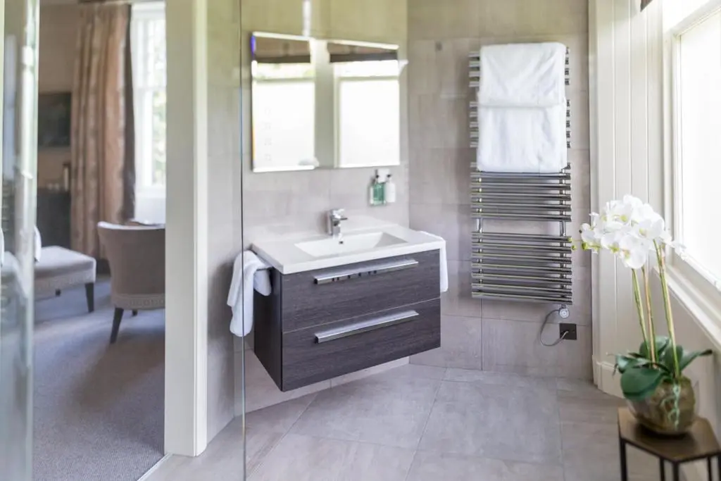 a bathroom with a sink and a mirror at The Dowans Hotel of Speyside in Aberlour