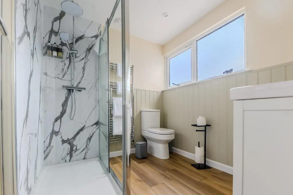 a bathroom with a shower and a toilet at Loch Ness Clansman Hotel in Drumnadrochit