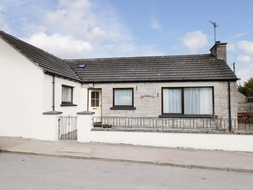 a white brick house with a black roof at Dalnahaven in Grantown on Spey