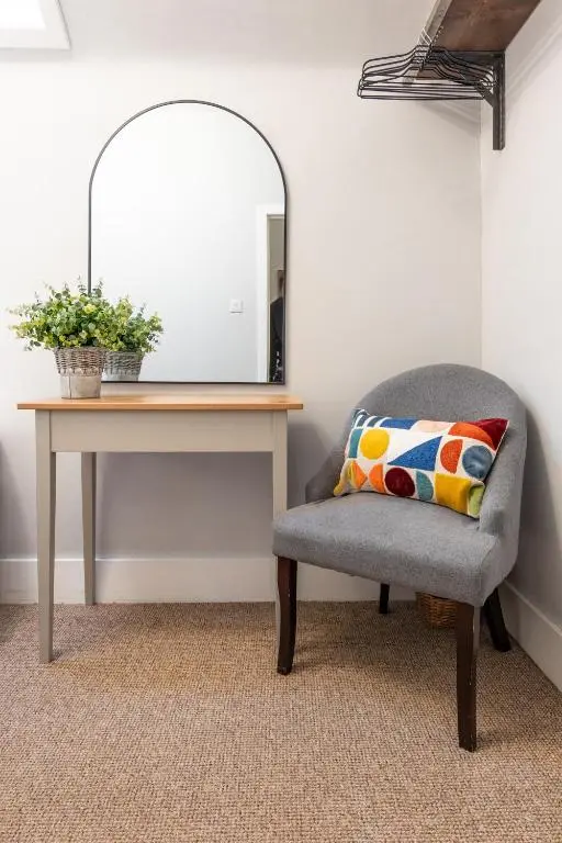 a desk with a chair next to a mirror at Taigh Carnan in Inverness