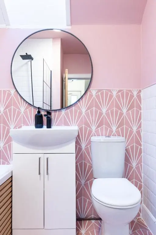 a bathroom with a white toilet and a mirror at Taigh Carnan in Inverness