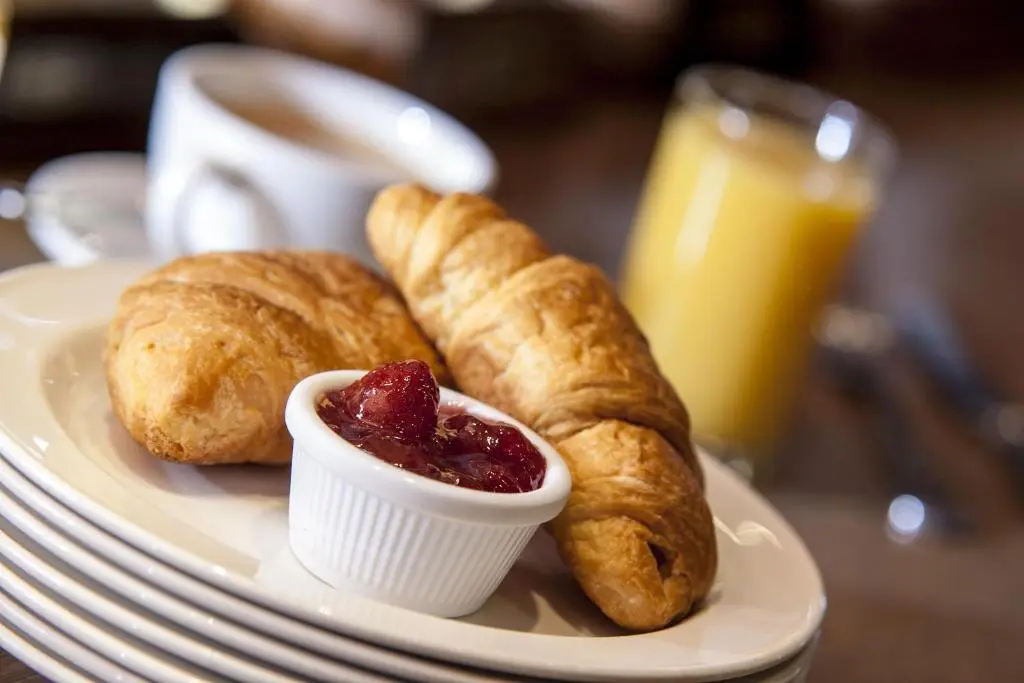 a plate of food with croissants and jam on it at The Glen Hotel Newtonmore - Rooms, bar & restaurant in Newtonmore