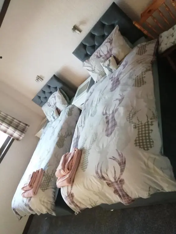 a bed with two pillows on top of it at Celicall in Ballater