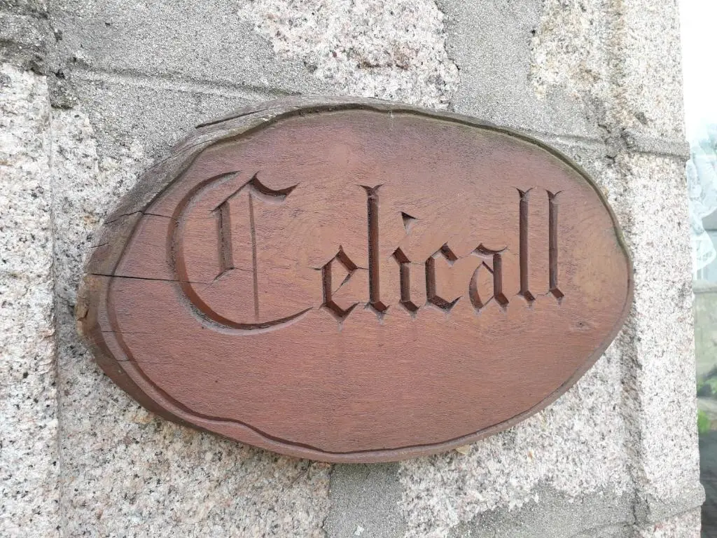 a metal plaque on the side of a wall at Celicall in Ballater