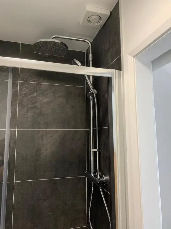 a shower with a shower head in a bathroom at Eastdene Guest House in Inverness