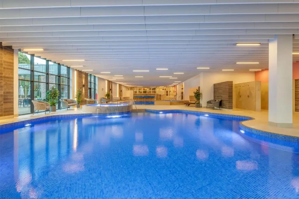 a large blue swimming pool in a building at Hilton Grand Vacations Club Craigendarroch Suites Scotland in Ballater