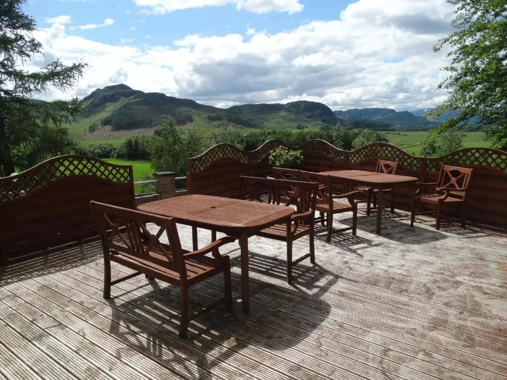 a group of tables and chairs on a patio at Laggan Hotel in Laggan