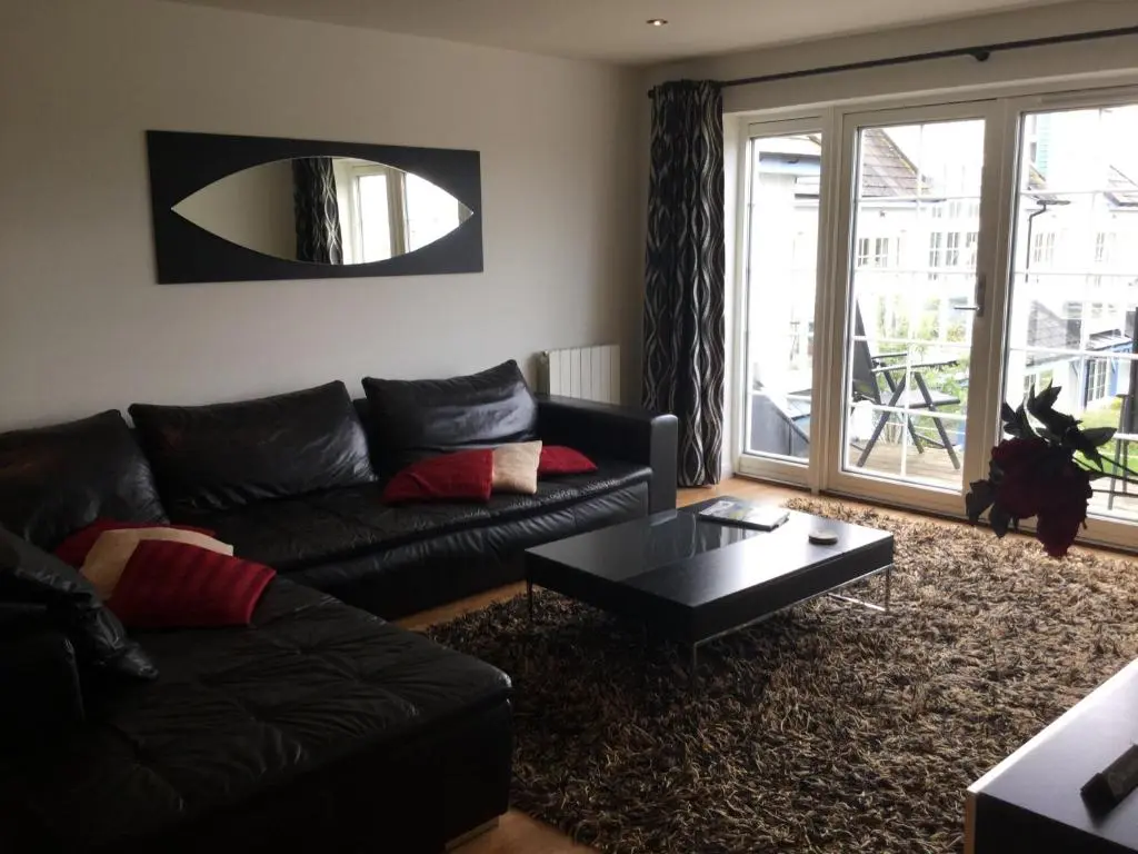 a living room with a couch and a coffee table at Castlefield Apartment Free Parking in Inverness