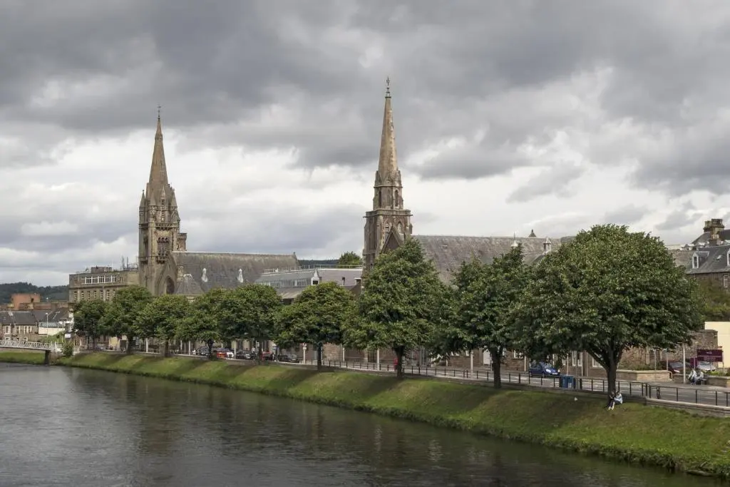 a view of a city with a river and cathedral at Silver Key Apartments in Inverness