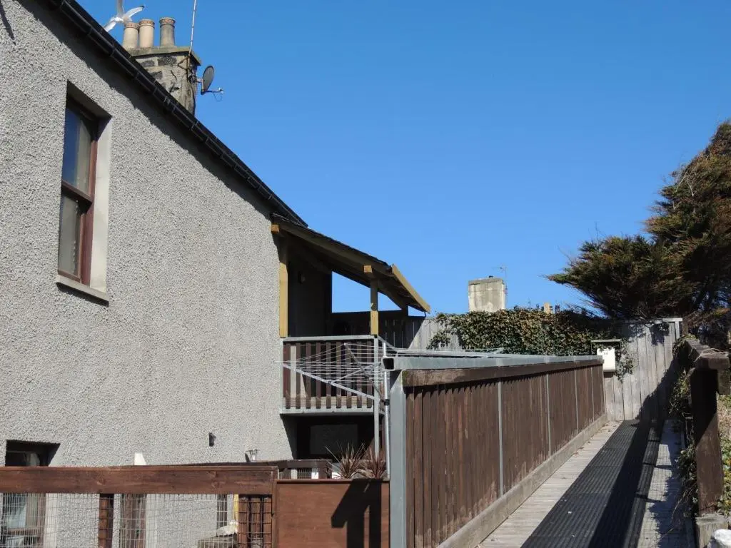 a balcony of a house with a wooden fence at 5A Union Road in Macduff
