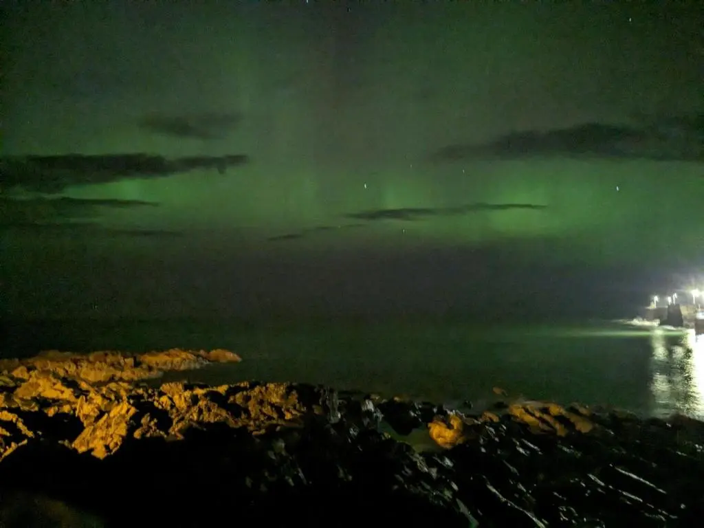 a boat in the ocean at night with green lights at 5A Union Road in Macduff