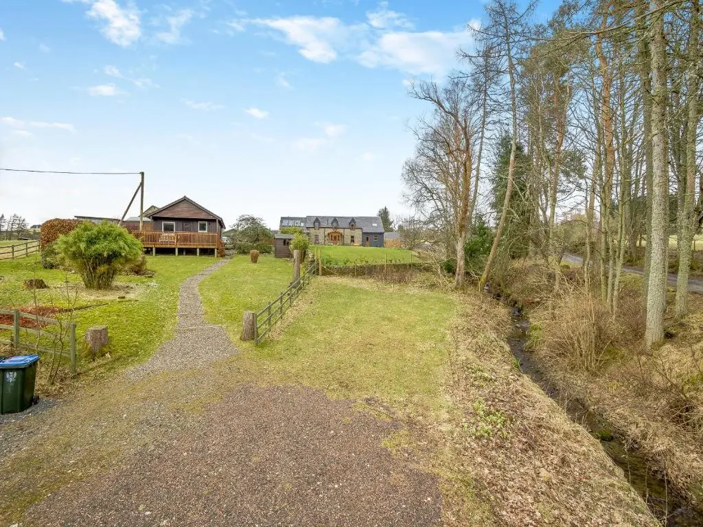 a path leading to a house in a field at Boreland Farm Cabin - Uk5855 in Kirkmichael
