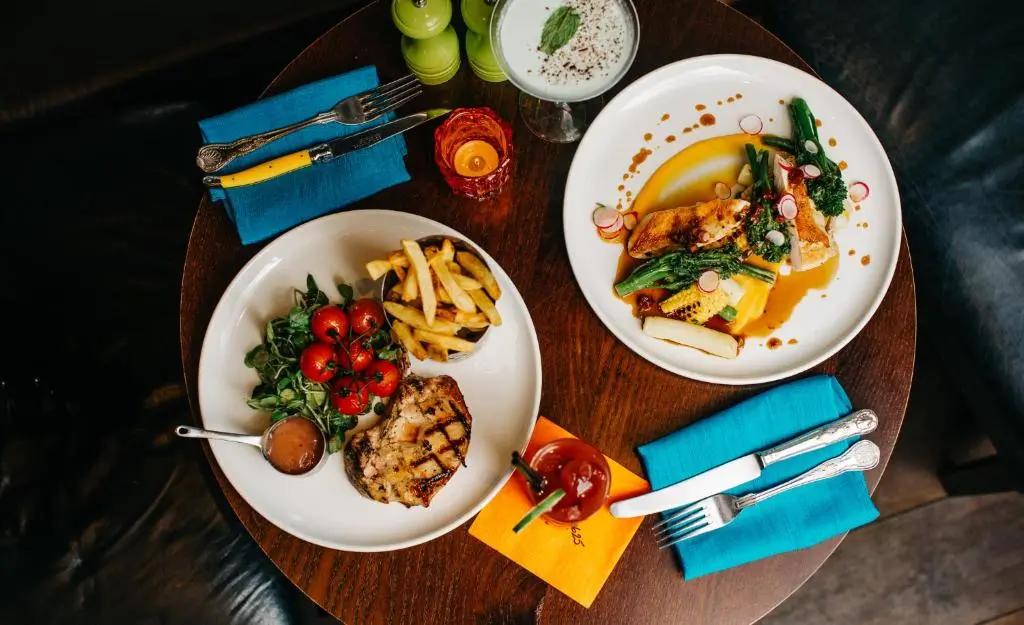 two plates of food on a wooden table at Banchory Lodge Hotel in Banchory