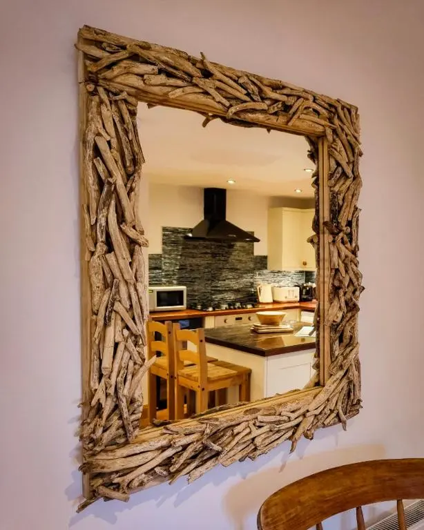a mirror hanging on a wall in a kitchen at Cullen 117 Seatown With Sea Views in Cullen