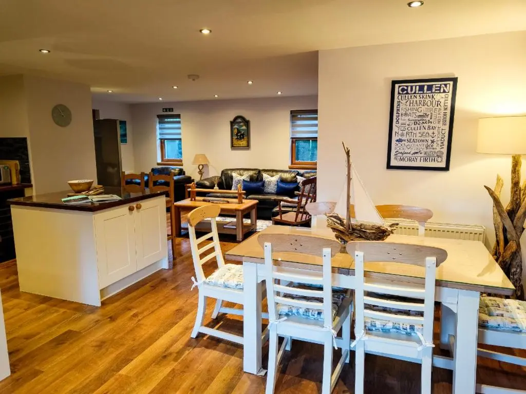 a kitchen and living room with a table and chairs at Cullen 117 Seatown With Sea Views in Cullen